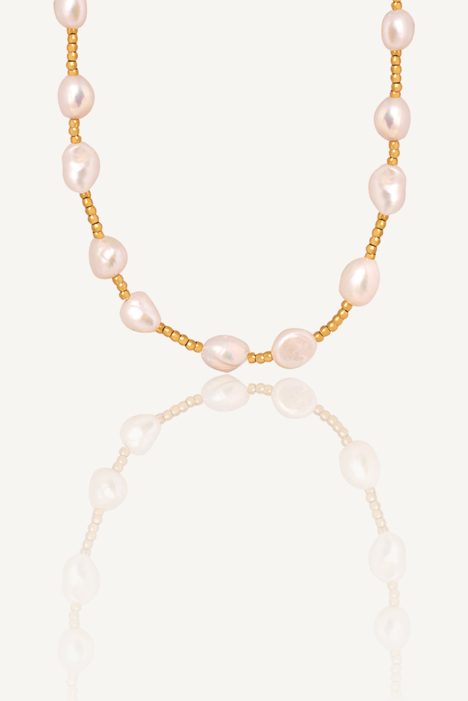 a necklace with pearls on a white background